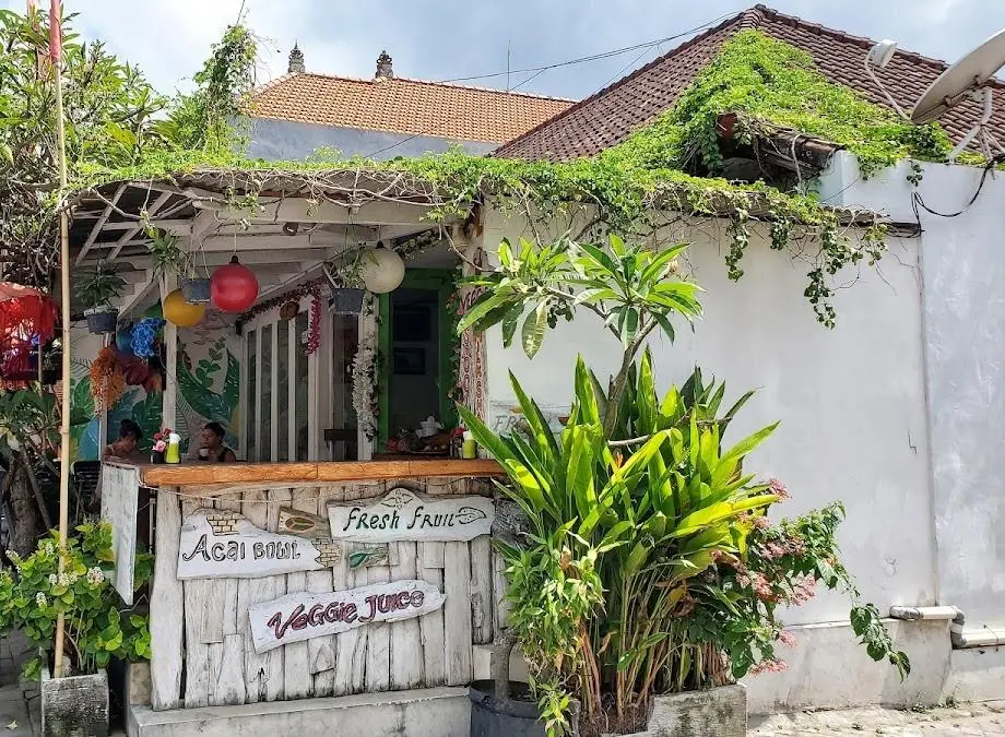 The open-air entrance and planted terrace at Warung Kecil Seminyak